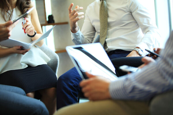 close up of small circle of people meeting