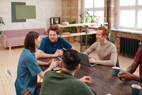 Professional team engaged in a collaborative work meeting in a modern office setting.
