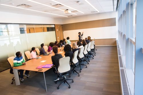 A diverse group actively collaborating in a bright, modern conference room setting