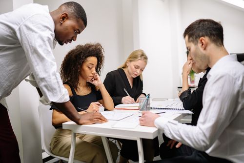A diverse group of colleagues working together in a modern office setting.