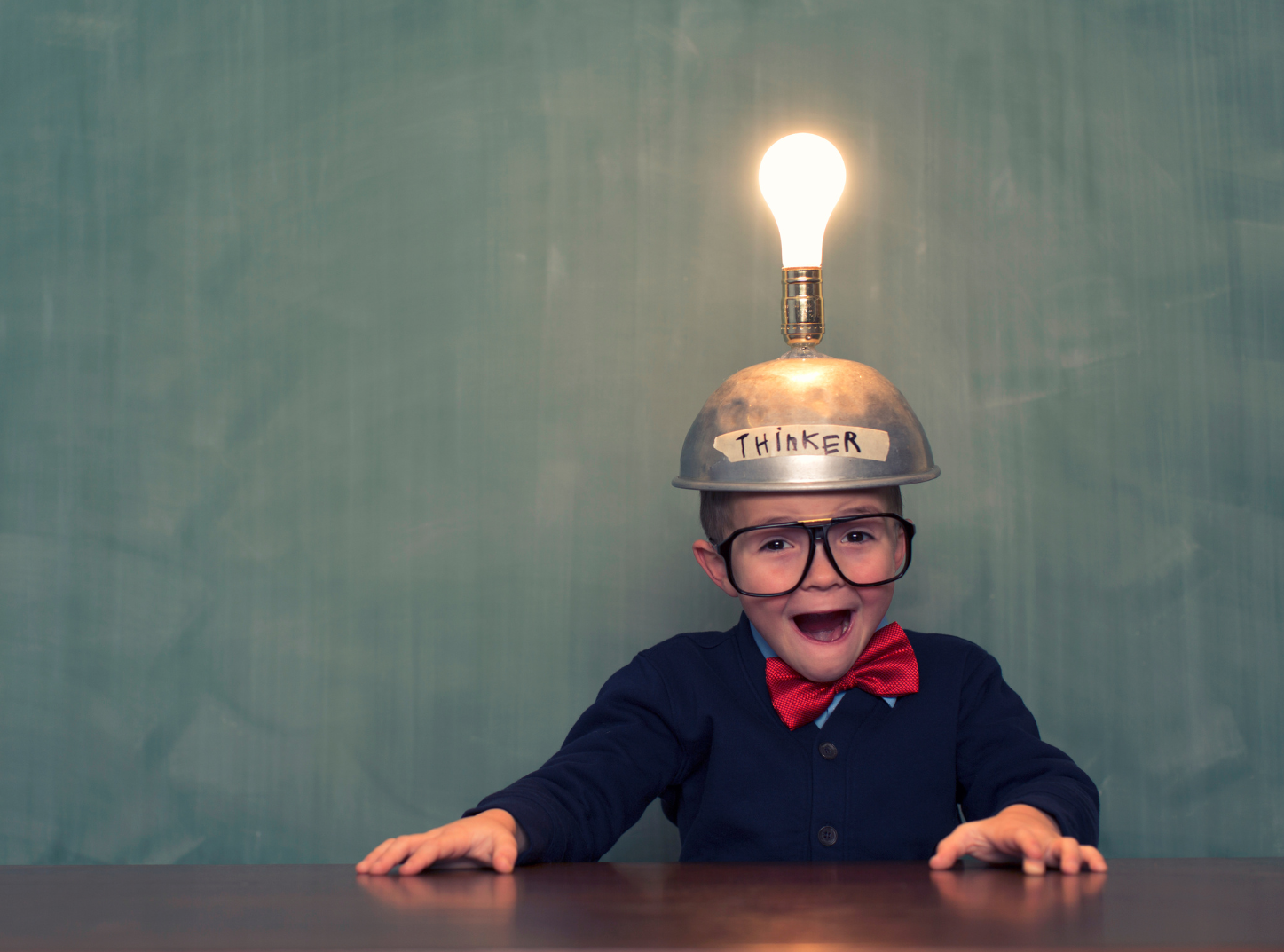 child with helmet and lightbulb